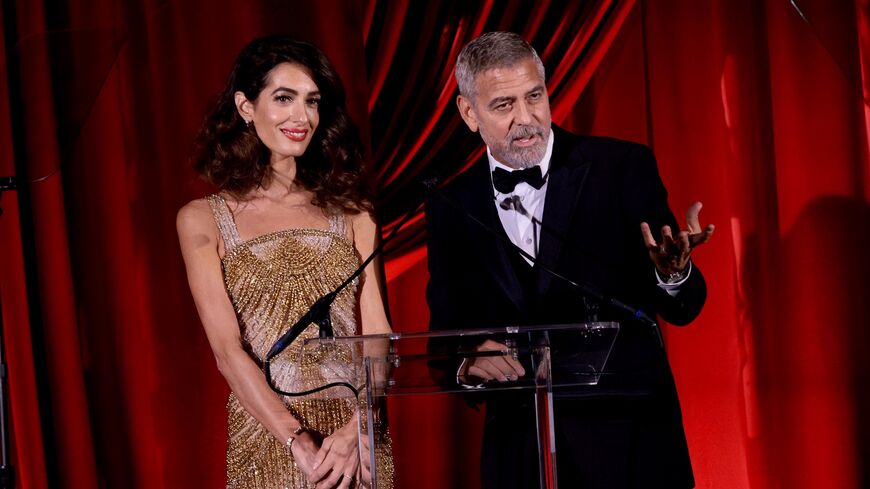 Amal and George Clooney speak onstage during the Clooney Foundation For Justice Inaugural Albie Awards at New York Public Library on September 29, 2022, in New York City.